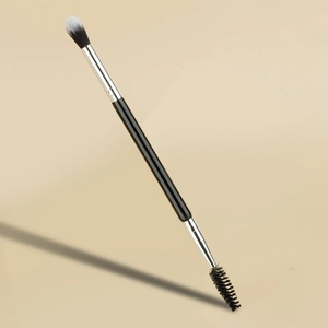 Detailed macro view of dual-ended makeup brush with blending bristles and spiral spoolie