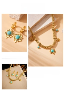 Detail of bohemian gold jewelry set featuring turquoise pendants and tree of life motifs