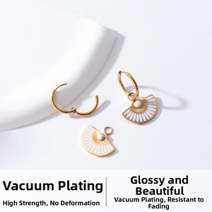 Detail of vacuum plated fan-shaped gold earrings with white enamel and marble bead