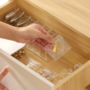 Clear PVC jewelry organizer bags and storage box set in a wooden drawer context