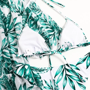 Detailed flat lay of green tropical print bikini set with sheer mesh cover-up in size S