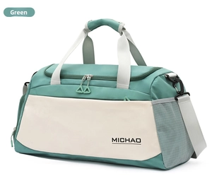 Green duffel bag detail showing durable dual handles, side mesh pocket, and front zipper compartment.