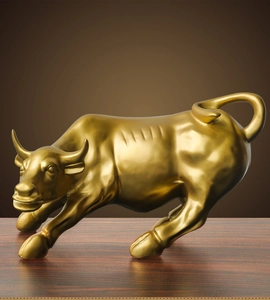 Detailed view of a golden bull figurine with muscular texture for office decor