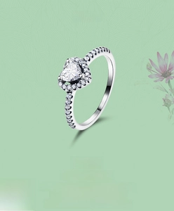 Macro shot of S925 sterling silver ring with heart-shaped zircon and pave setting