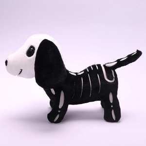 Side view of a plush Halloween skeleton dog toy with bone patterns on a purple background