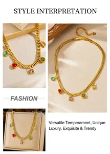 Detail of gold-plated thick chain necklace featuring colorful gemstone heart and drop charms