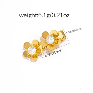 Detailed view of gold flower hair clips with clear crystals showing size and weight specs