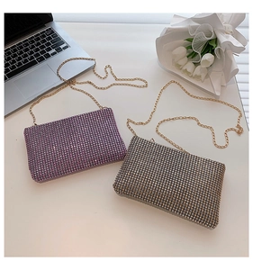 Detail of pink and gold rhinestone envelope clutch bags with elegant metal chain straps