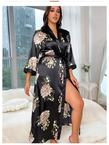 Detail of plus size black satin floral robe showing smooth silk-like texture and elegant drape