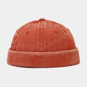 Detail of vintage washed docker hat showing rust red fabric texture and metal eyelets