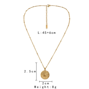 Detail view of a gold zodiac pendant necklace with a deer relief and chain measurements