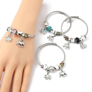 Detail of stainless steel wire bracelets with crystal beads and elephant pendants