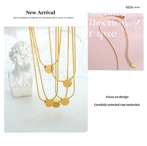 Detailed view of 18K gold plated snake chain necklace with engraved Fu cylinder pendant