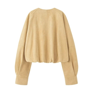 Detail view of the back of a light camel faux suede jacket featuring lantern sleeves
