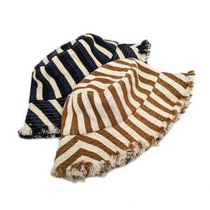 Striped cotton bucket hat with frayed edges in navy and brown colors on white background