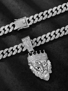 Detail shot of iced out lion head pendant with sparkling rhinestones on cuban chain