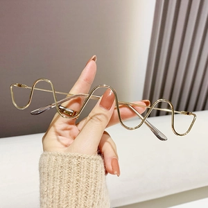 Golden wavy diamond-encrusted rimless glasses frame with artistic metal S-curve design