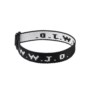 Detail of adjustable black nylon WWJD woven bracelet with white lettering and buckle
