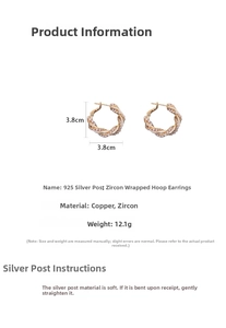 Detail view of gold twisted hoop earrings with cubic zirconia, 3.8cm diameter and 925 silver needle