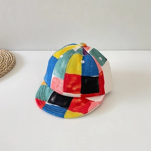 Detailed view of colorful patchwork pattern and canvas texture on kids baseball cap