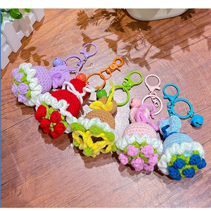 Detailed view of colorful handmade crochet flower bouquets with metal rings on wood