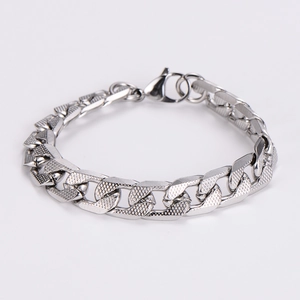 Detailed view of silver stainless steel curb chain bracelet with secure lobster clasp