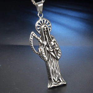 Macro shot of silver stainless steel Grim Reaper pendant with scythe and scales