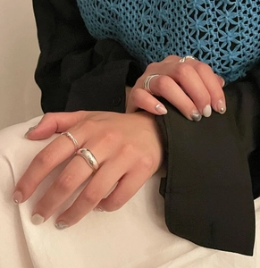 Chic 925 sterling silver knotted rings stacked on fingers for a trendy minimalist look