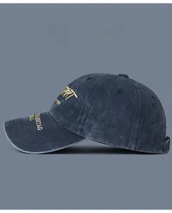 Detailed close-up of retro washed cotton baseball cap with golden embroidery