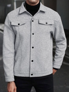 Detail of grey textured wool-blend shirt jacket with chest pockets and black buttons
