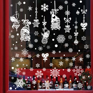 White Christmas window decals featuring Santa Claus, snowflakes and stars on red frame
