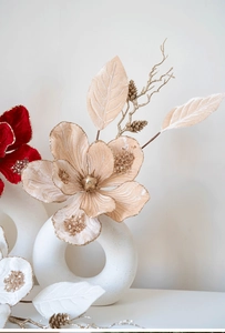 Champagne magnolia and red velvet flowers with glitter in a white ring ceramic vase