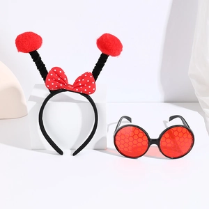 Close-up of red polka dot ladybug headband and honeycombed circular glasses set