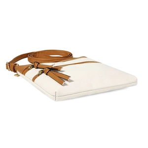 Close-up of white and brown contrast crossbody bag featuring dual bow zipper details
