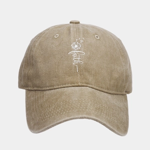 Detail of khaki cotton baseball cap with faith dandelion print and washed vintage texture