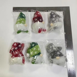Detailed view of LED lighted Christmas gnome ornaments in red green and grey with measuring scale