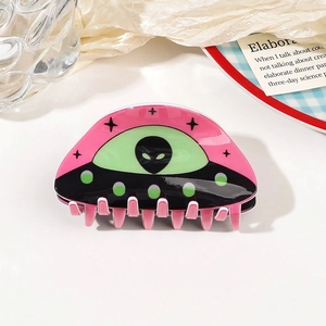 Close-up of pink and green UFO acrylic hair claw clip with star patterns for creative styling