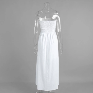 Detail of the smocked elastic bodice and textured cotton fabric on a white tube dress