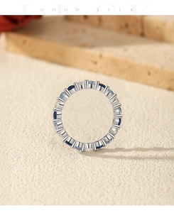 Close-up of S925 sterling silver ring featuring gradient blue and clear oval gemstones