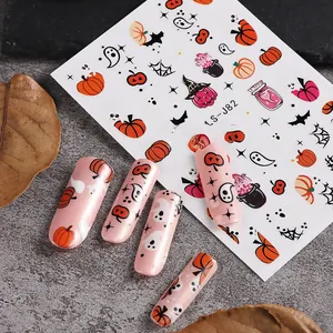 Close-up of Halloween nail stickers LS-J82 with pumpkin, ghost and bat patterns on pink nails