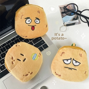 Three plush potato coin purses with different funny facial expressions on a desk