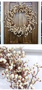 Macro view of artificial white berries and brown twigs on a festive Christmas wreath