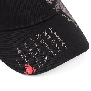 Macro detail of twill cotton baseball cap brim with vintage prints and red logo