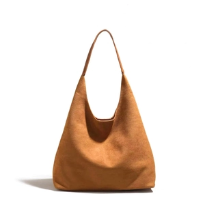 Close-up of a large brown suede hobo shoulder bag with minimalist integrated strap