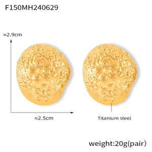 Detailed view of irregular textured golden titanium steel earrings with floral relief pattern
