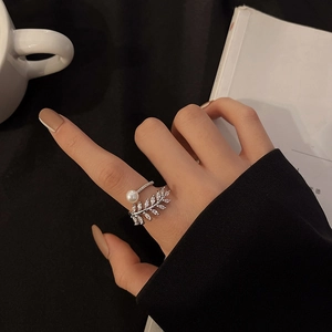Elegant silver leaf ring with sparkling zircons and pearl on a lifestyle model view