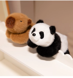 Close-up of soft plush panda and capybara toys with fluffy faux rabbit fur texture