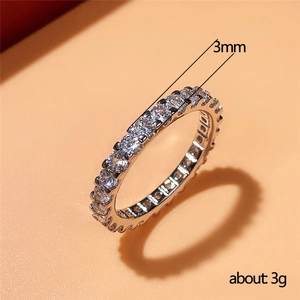 3mm silver eternity ring with full zircon inlay, weighing 3g on a peach background