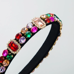Detailed macro view of baroque headband featuring colorful crystals and golden claw settings