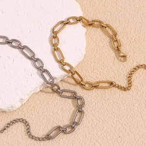 Close-up of gold and silver paperclip chain links with lobster clasp and extender
